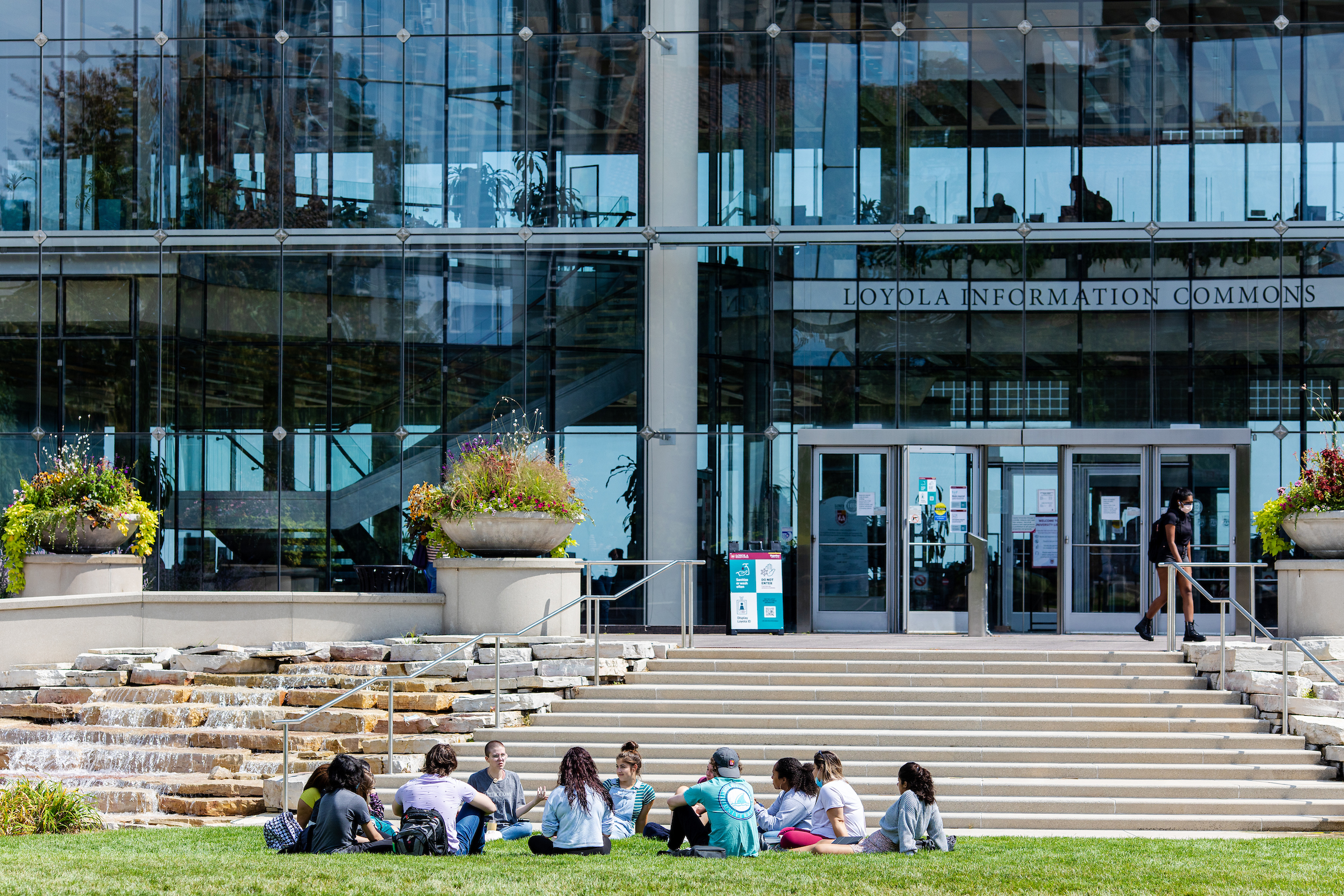 Students sitting on the quad in front of the Information Commons